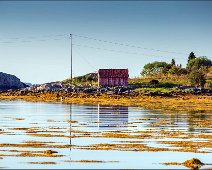 Mirror Hut A small hut in Lofoten, Norway, reflected in the lake.