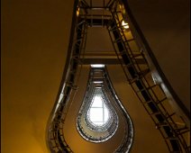 Light bulb Staircase in Prague A view up in a staircase reveals a kind of light bulb opening on the roof of the builduing.