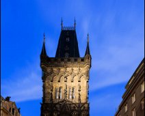 Powder Gate Tower The historical Powder Gate Tower in the old town of Prague at dawn. A car is driving through the gate of the tower.