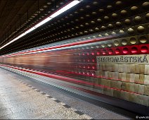 Staroměstská Station Prague Metro The metro station Staroměstská in Prague, a underground station with a unique design and architecture. A metro train is moving out of the station.